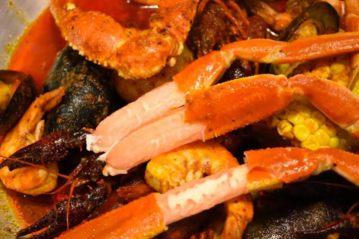 Spicy mixed seafood boil with snow crab crawfish mussels corn at Red Crab Juicy Seafood, a Seafood Restaurant in Brooklyn