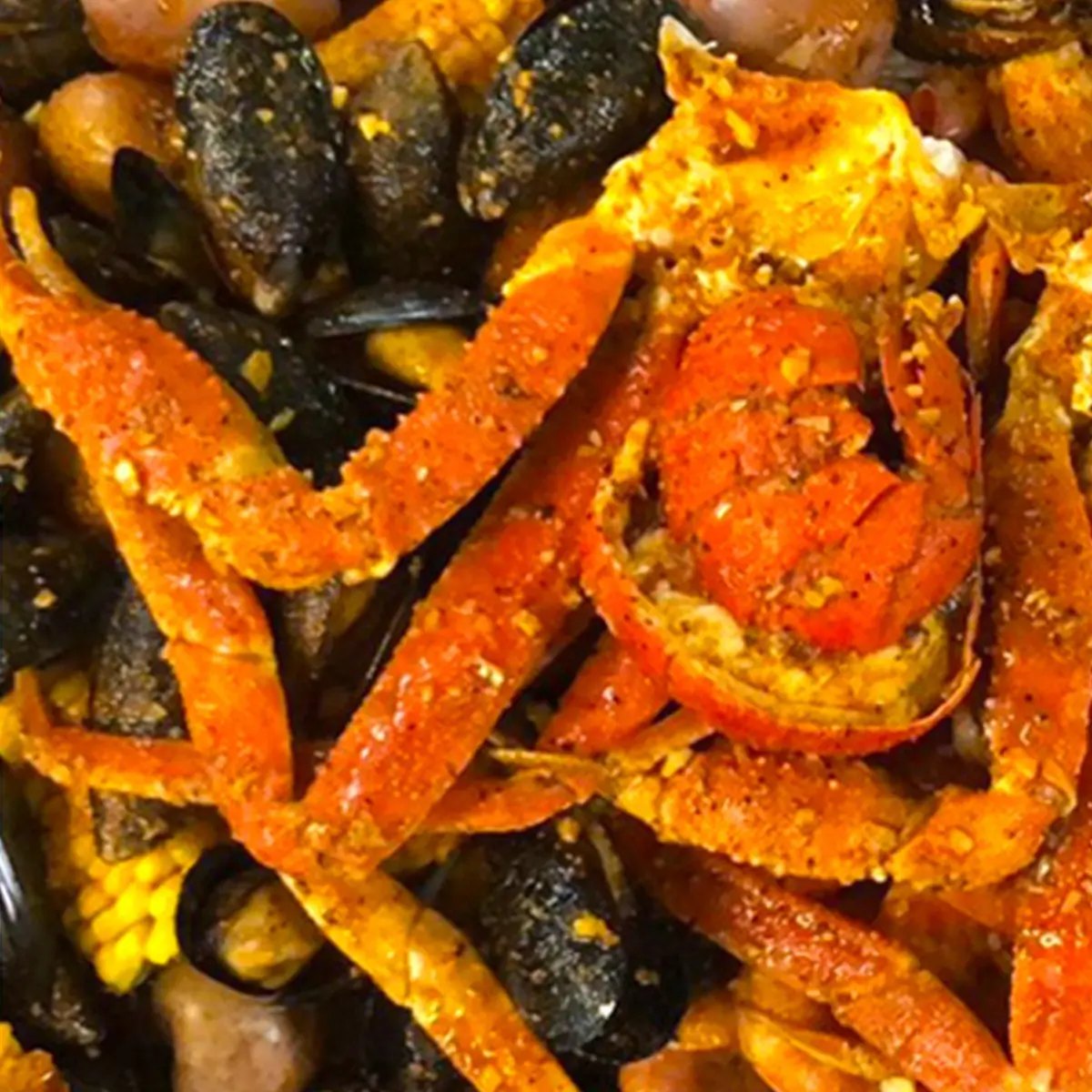 Spiced snow crab mussel corn loaded seafood boil platter at Red Crab Juicy Seafood, a Seafood Restaurant in Brooklyn